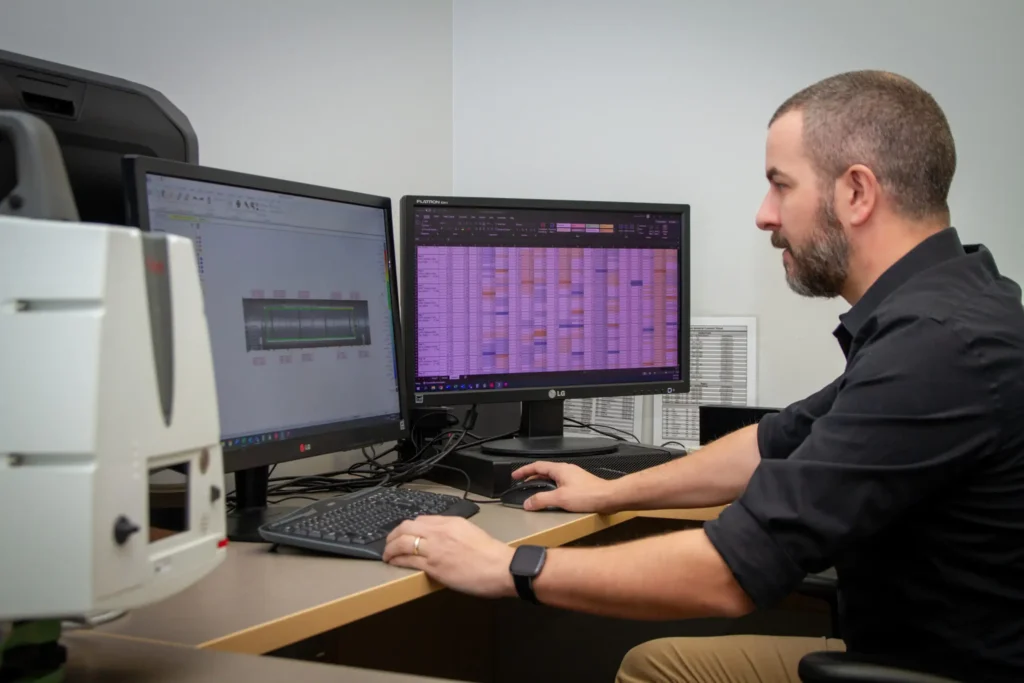 engineer analyzing a 3D model on a computer